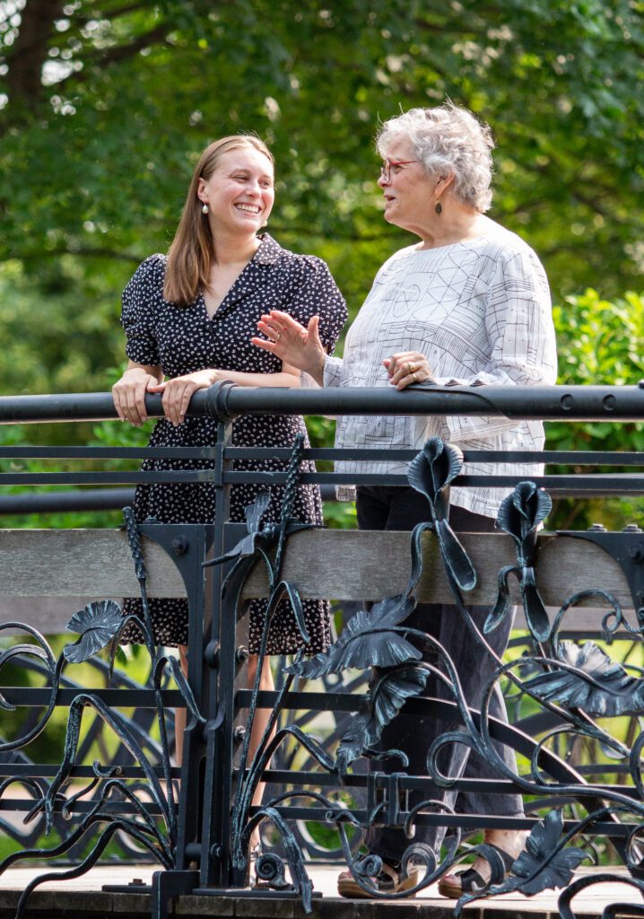 Jessie and Executive Director Niki Thrash standing talking on a bridge